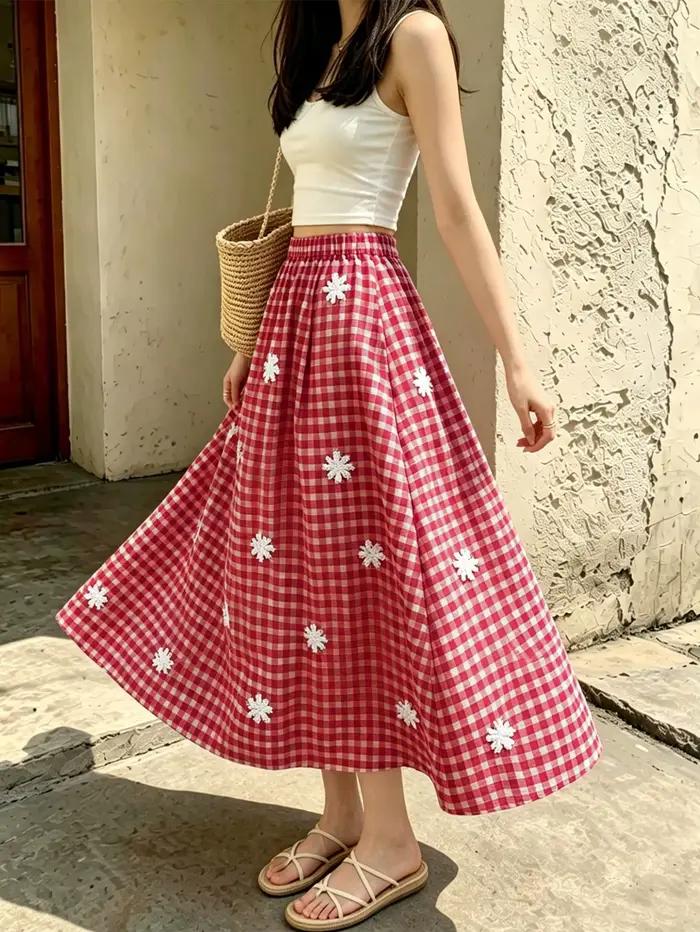 Jupe mi-longue à taille haute, à carreaux rouges, brodée de fleurs et de flocons de neige, avec tail
