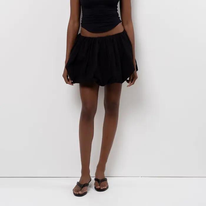 Femmes lanterne Mini jupes été décontracté coupe ample taille élastique couleur unie courte jupe bouffante Style doux