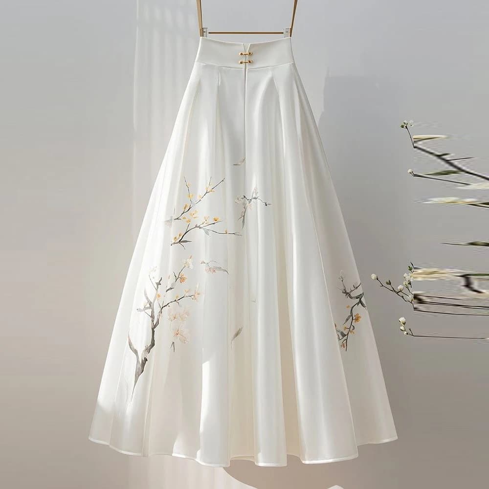 Jupe midi blanche avec un sentiment de drapé pour les femmes d'automne 2025, nouveau style super fée