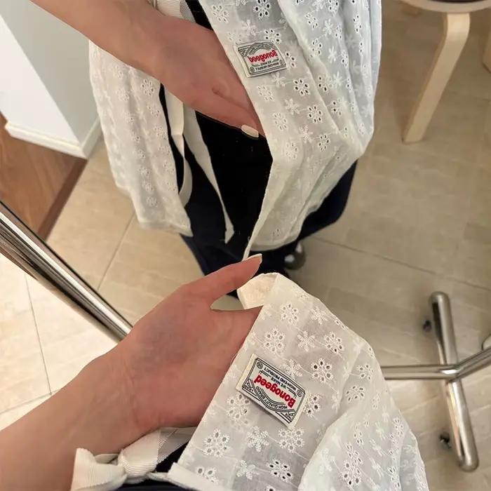 Jupe mi-longue ajourée en dentelle superposée avec ceinture